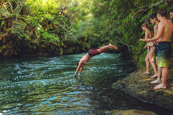 Kids diving into a river